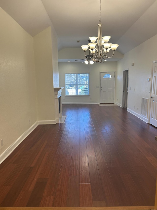 entrance foyer with a chandelier, lofted ceiling, and dark wood-type flooring