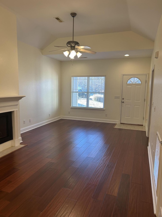 unfurnished living room featuring dark hardwood / wood-style flooring, ceiling fan, and lofted ceiling