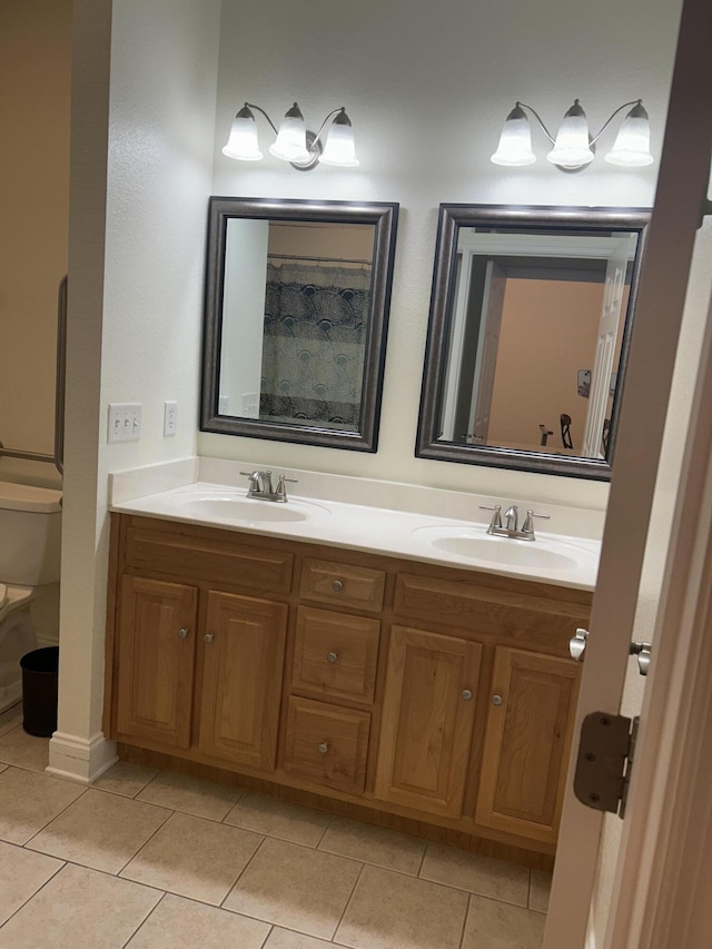 bathroom featuring tile patterned flooring, vanity, and toilet