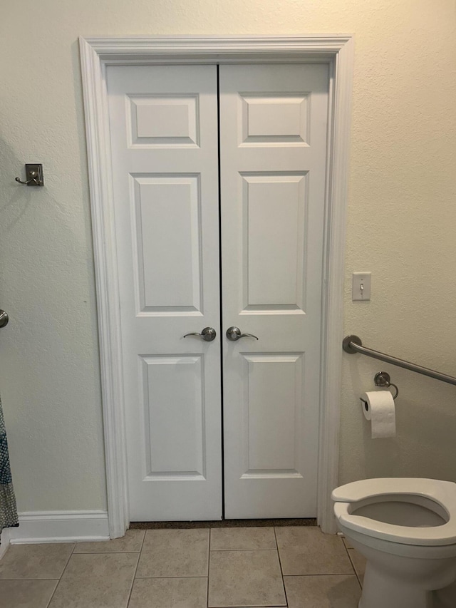 bathroom featuring tile patterned floors and toilet