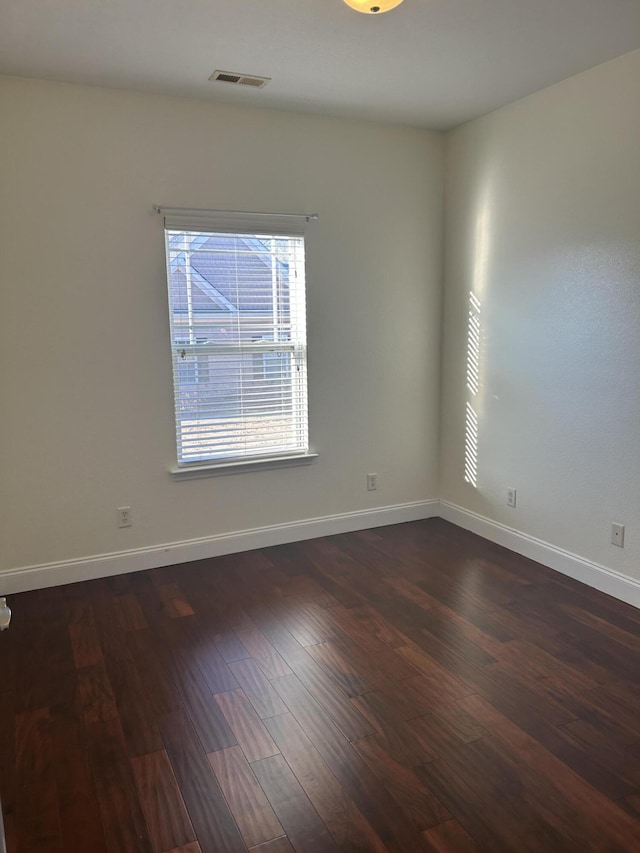 unfurnished room featuring dark hardwood / wood-style floors