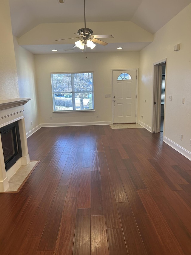 unfurnished living room with lofted ceiling, ceiling fan, and dark wood-type flooring