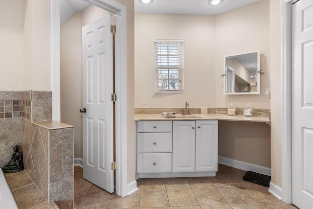 bathroom featuring tile patterned flooring and vanity