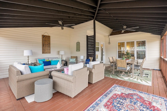 view of patio featuring a deck, ceiling fan, and outdoor lounge area