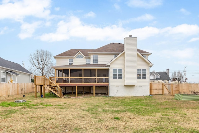 back of house featuring a yard and a sunroom