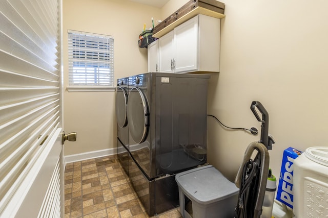 laundry area featuring independent washer and dryer and cabinets