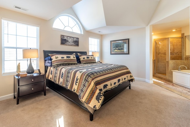 bedroom with lofted ceiling, light carpet, and multiple windows