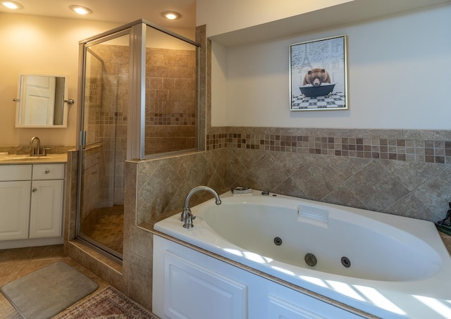 bathroom featuring tile patterned floors, plus walk in shower, and vanity