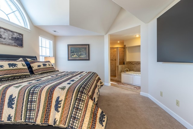 carpeted bedroom with lofted ceiling and ensuite bath