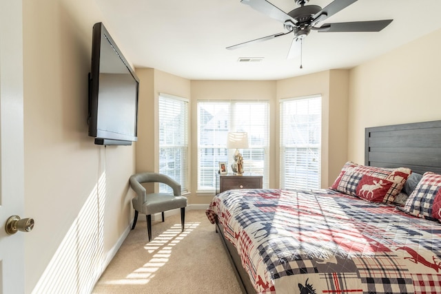 bedroom featuring light carpet and ceiling fan