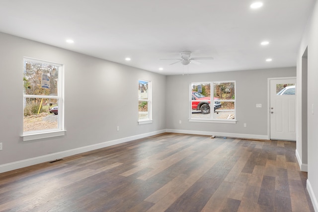 spare room featuring dark hardwood / wood-style floors, plenty of natural light, and ceiling fan