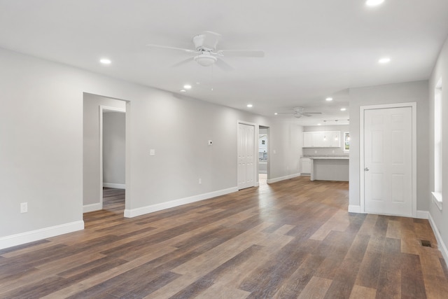 unfurnished living room with ceiling fan and dark hardwood / wood-style floors