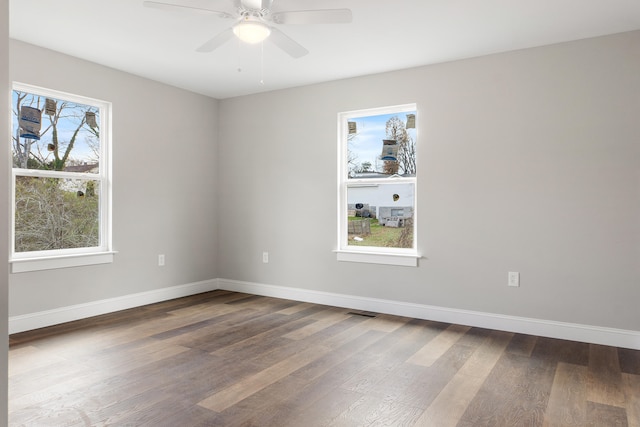 empty room with ceiling fan and hardwood / wood-style floors