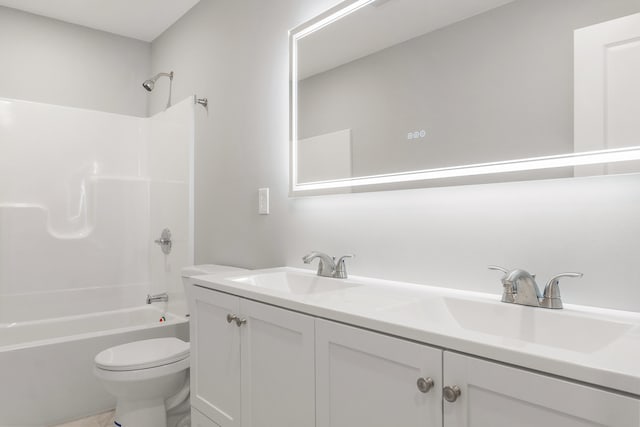 full bathroom with shower / tub combination, vanity, and toilet