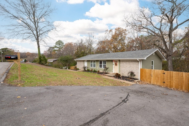 ranch-style home with a front yard