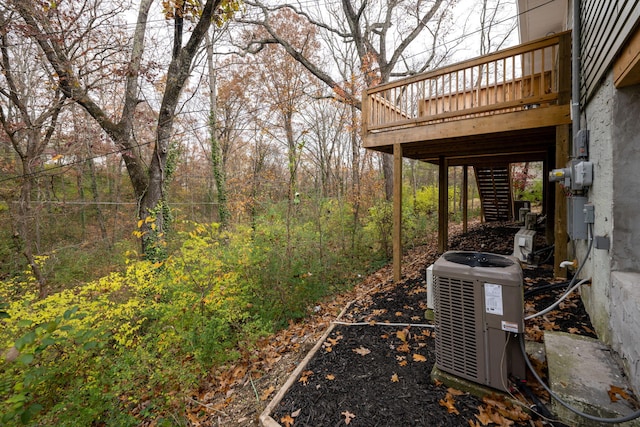 view of yard with a wooden deck and central air condition unit