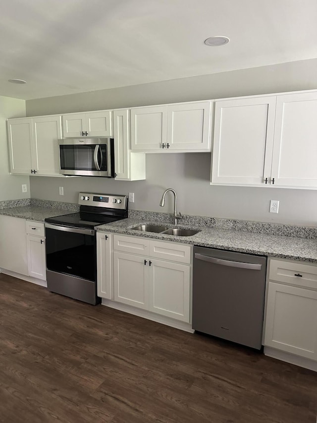 kitchen with white cabinets, stainless steel appliances, dark wood-type flooring, and sink