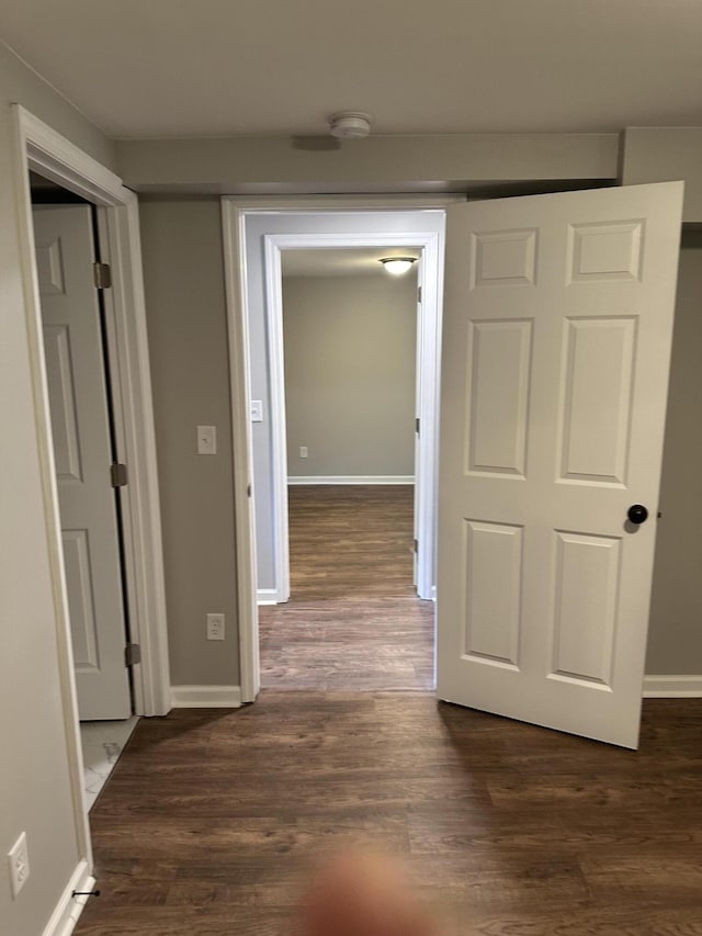 corridor featuring dark wood-type flooring