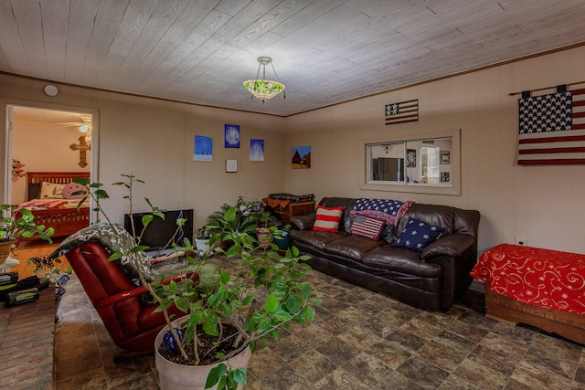 living room with wooden walls, crown molding, and wood ceiling