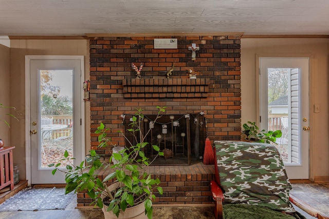 living room with crown molding and a fireplace