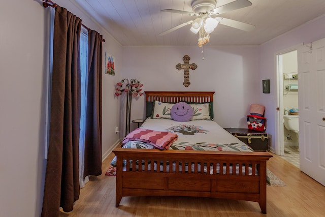 bedroom with ensuite bath, ceiling fan, and light wood-type flooring