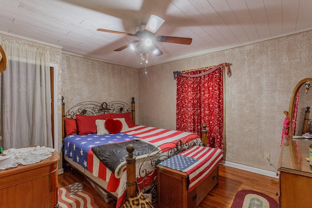 bedroom with crown molding, ceiling fan, and dark wood-type flooring