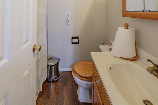 bathroom featuring vanity, toilet, and wood-type flooring