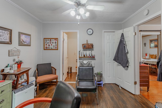 sitting room with ceiling fan, dark hardwood / wood-style floors, and ornamental molding