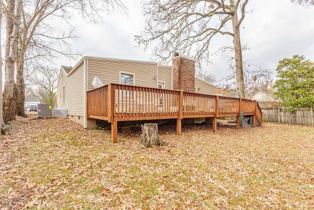 rear view of house featuring a wooden deck