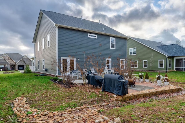 back of house with a patio and a lawn