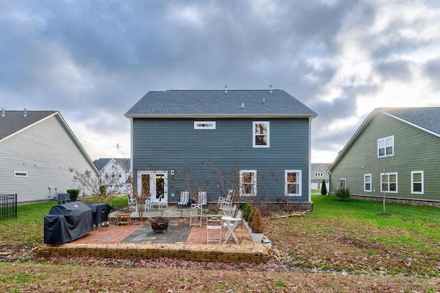 rear view of property with a lawn, central air condition unit, and a patio