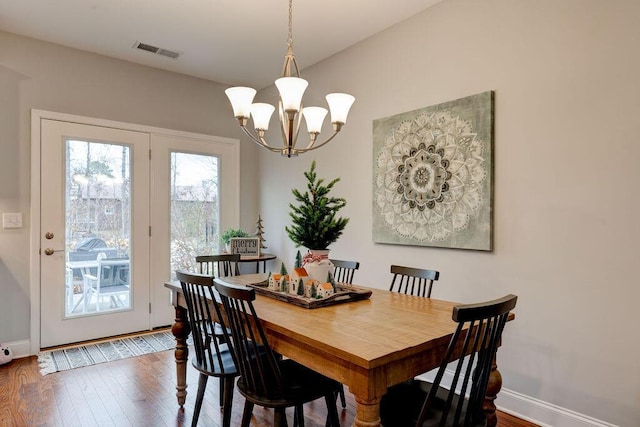 dining room with a chandelier and hardwood / wood-style flooring