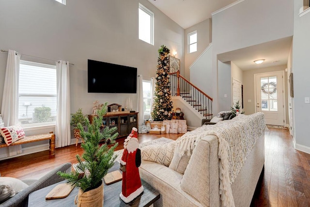 living room featuring a towering ceiling and a wealth of natural light