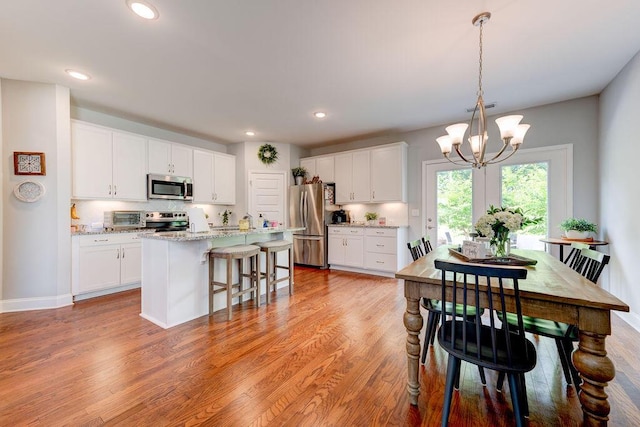 1494 Buttonwood, Chattanooga, TN 37421 - kitchen with appliances with stainless steel finishes, a chandelier, white cabinets, and recessed lighting