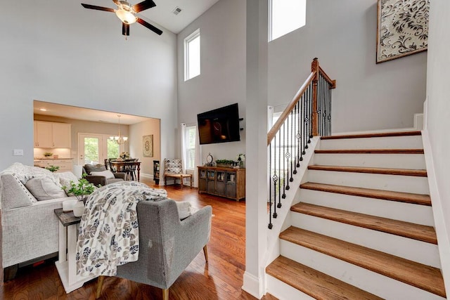 1494 Buttonwood, Chattanooga, TN 37421 - living room with a towering ceiling, stairway, a ceiling fan, wood finished floors, and a chandelier