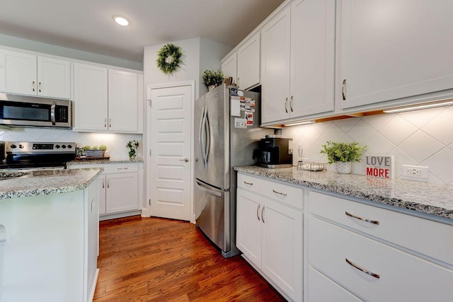 1494 Buttonwood, Chattanooga, TN 37421 - kitchen with stainless steel appliances, decorative backsplash, white cabinets, wood finished floors, and recessed lighting
