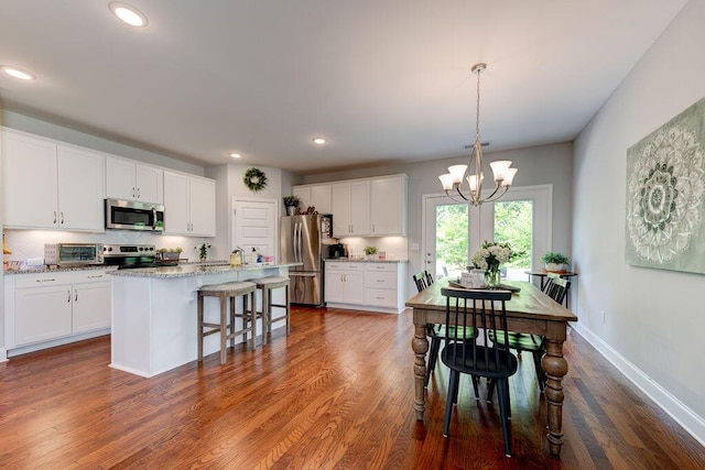1494 Buttonwood, Chattanooga, TN 37421 - kitchen with appliances with stainless steel finishes, a chandelier, white cabinets, decorative backsplash, and recessed lighting