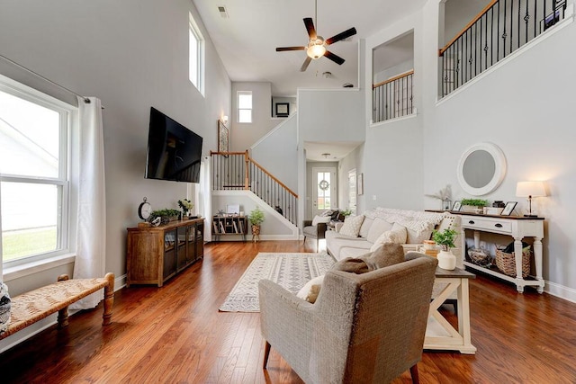 1494 Buttonwood, Chattanooga, TN 37421 - living area featuring stairs, a towering ceiling, a ceiling fan, wood finished floors, and baseboards