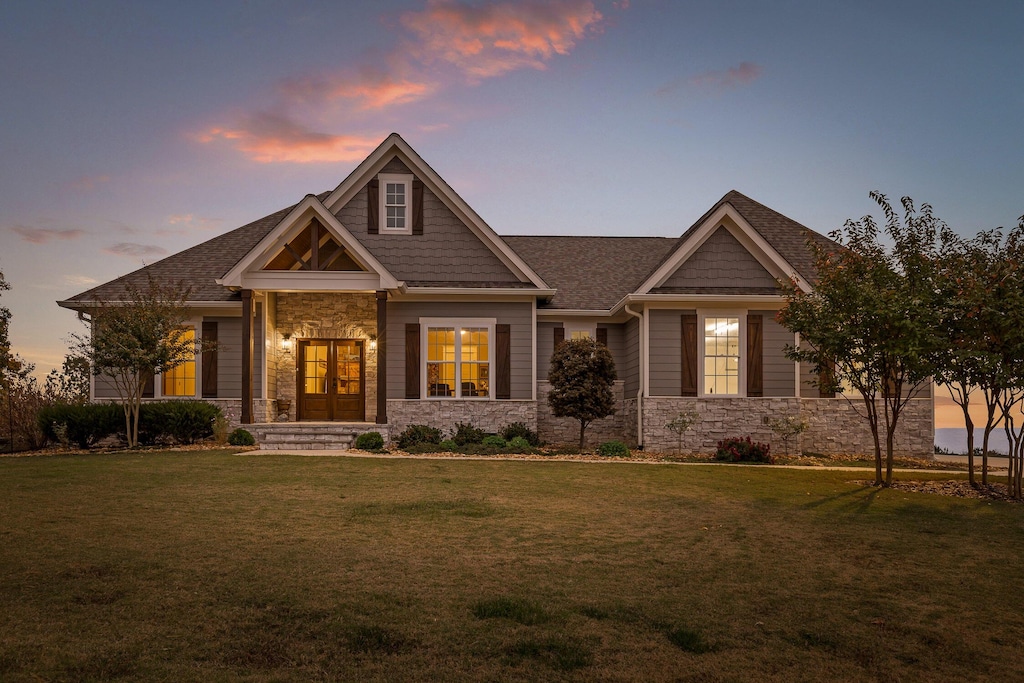 craftsman inspired home with a lawn and french doors