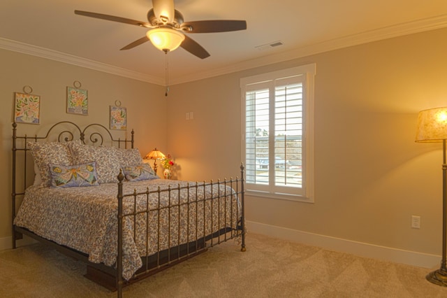 bedroom with ceiling fan, carpet, and ornamental molding