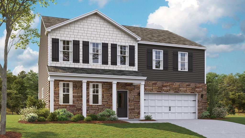 view of front of property with a front yard and a garage