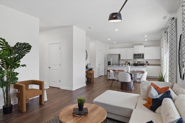 living room with dark hardwood / wood-style flooring