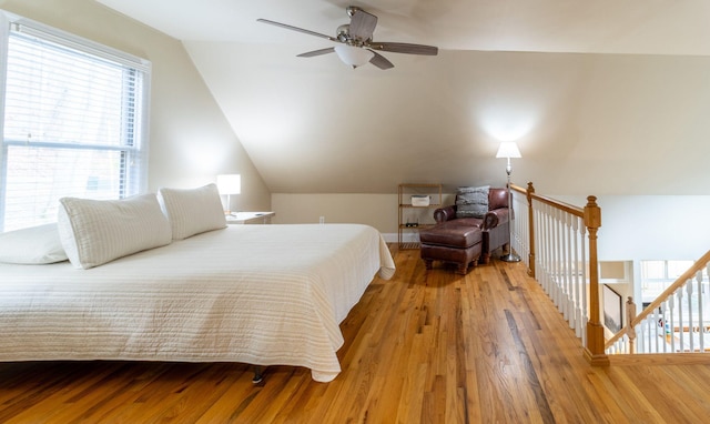 bedroom with ceiling fan, lofted ceiling, and hardwood / wood-style flooring