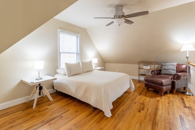 bedroom featuring ceiling fan, vaulted ceiling, and light wood-type flooring