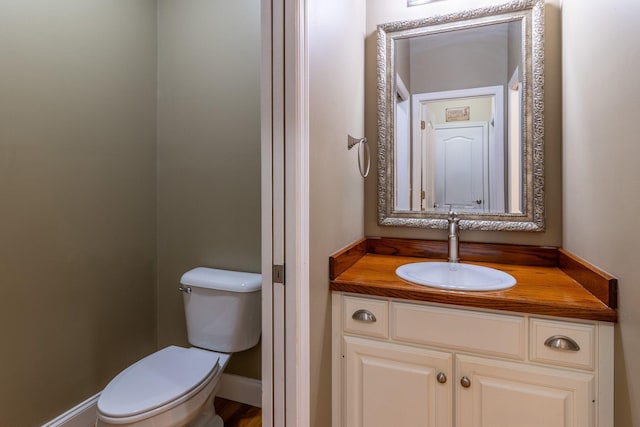 bathroom featuring toilet and vanity