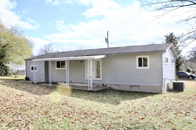 back of property featuring a yard and cooling unit