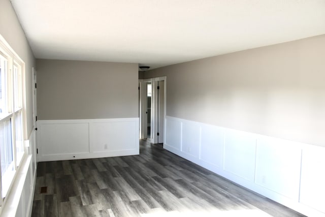 spare room with dark hardwood / wood-style flooring