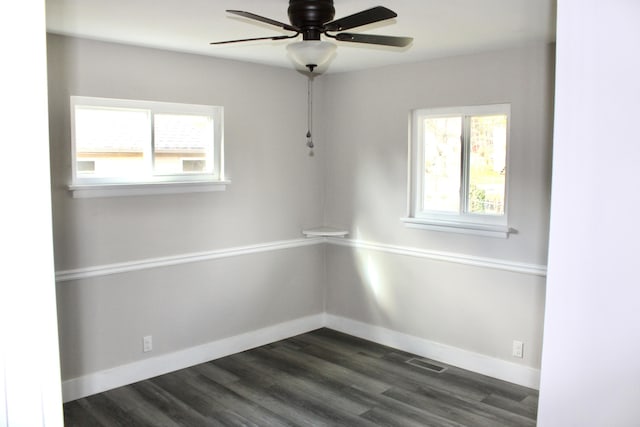 unfurnished room with ceiling fan and dark wood-type flooring