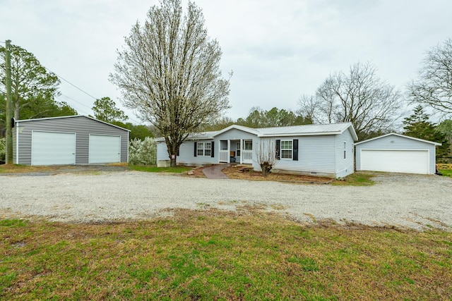 ranch-style home with a front yard, a garage, and an outdoor structure