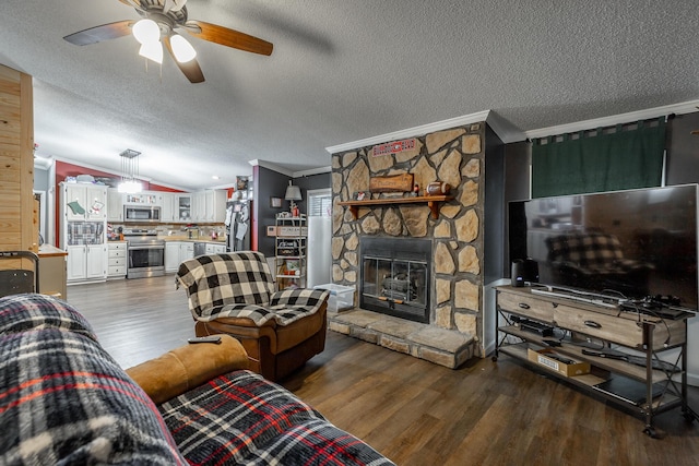 living room featuring a fireplace, a textured ceiling, hardwood / wood-style flooring, and crown molding